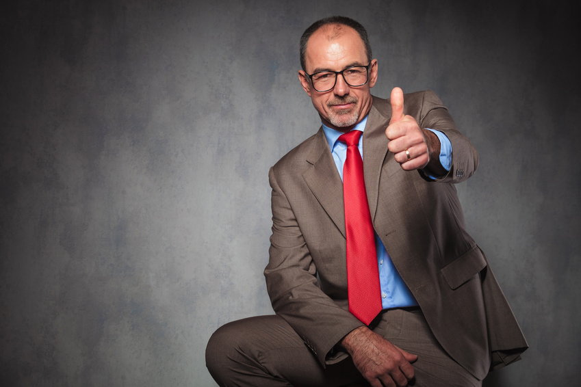 confident senior entrepreneur showing thumbs up